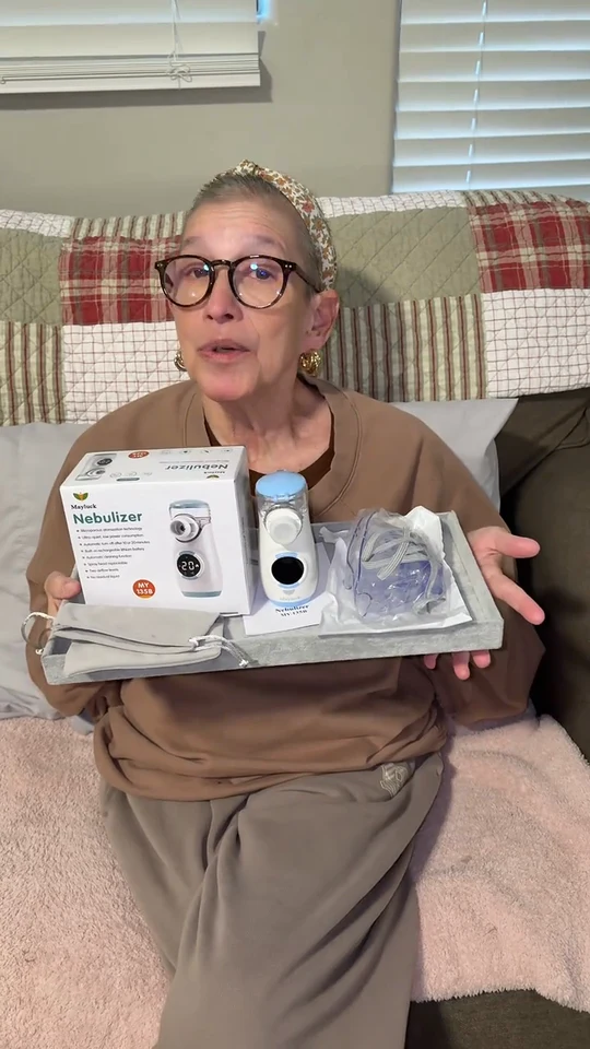 Donations4mom seated at home, showing her Mayluck device and accessories