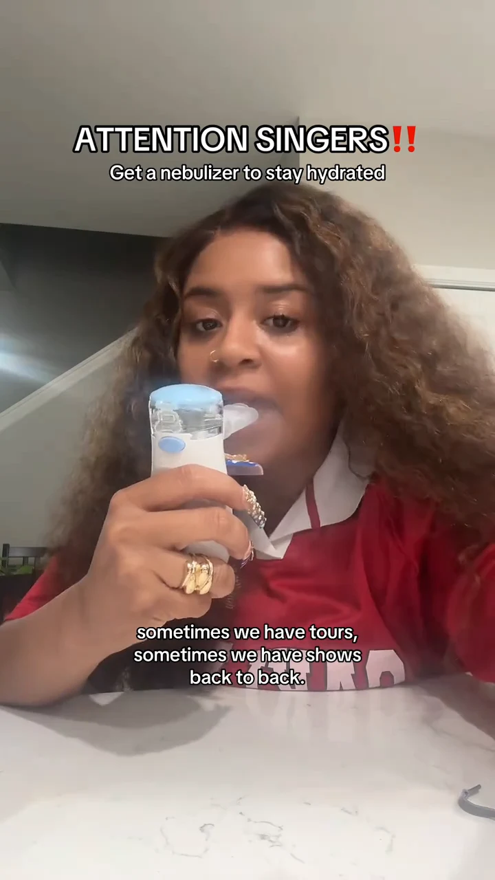 Singer thesingerchazz holding her real nebulizer with its connected mouthpiece at her lips